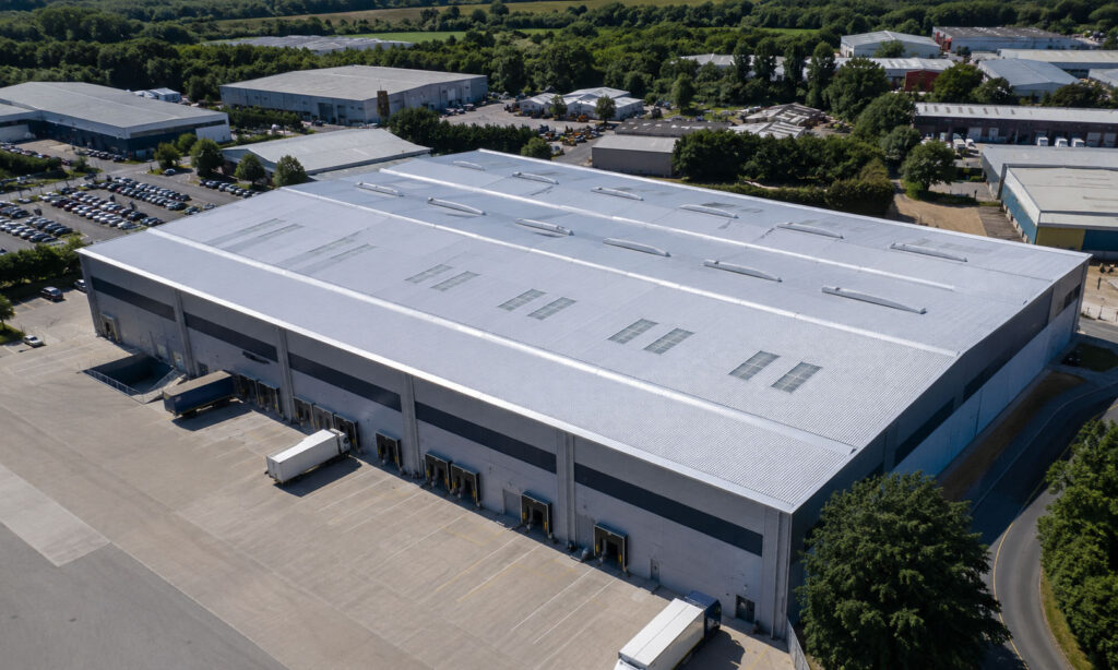 Large industrial warehouse with metal roofing and rooflights in Kent